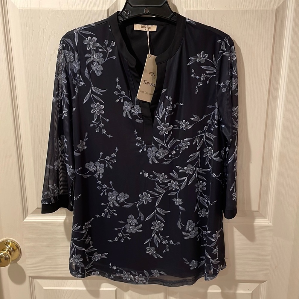 Black floral top.  V-neck.  Shear sleeves.  Size M.